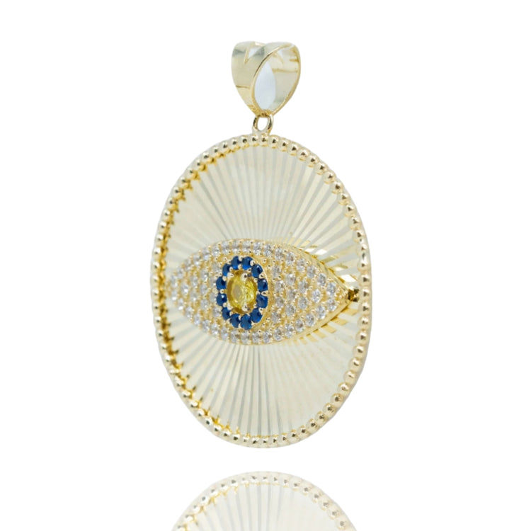 The Eye Pendant – 10k features a gold oval design with a textured radiating pattern, a central eye motif set with blue and clear stones, and a smooth gold bail—a bold choice for men's jewelry.
