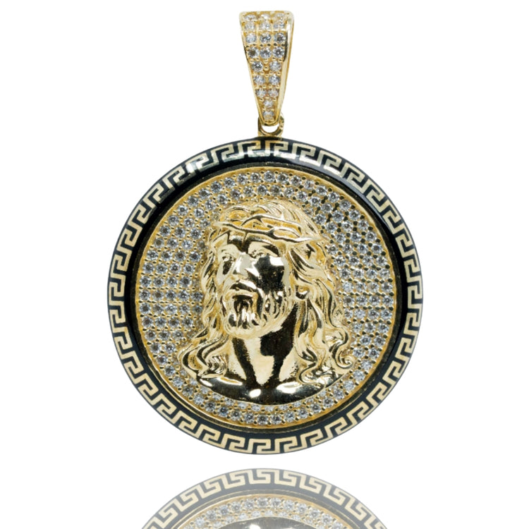The Christ Circular Portrait Pendant - 10k Gold features a raised bearded man's head, gold and black Greek key border, and sparkling stones for a striking religious look.