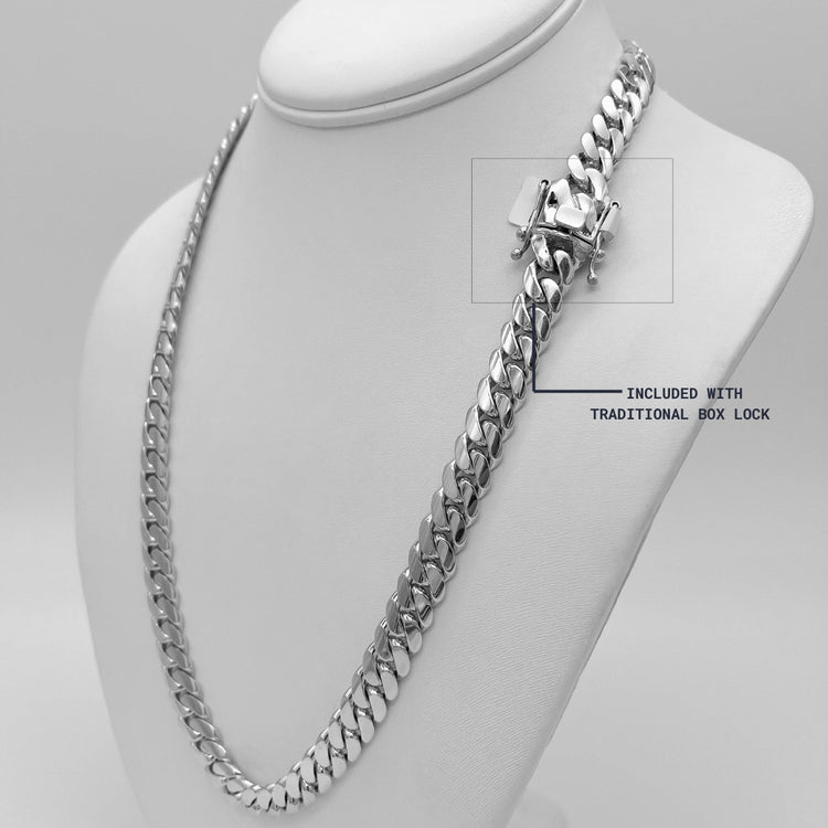 The 8mm Handmade Miami Cuban Link Chain - 950 Silver is displayed on a white stand, featuring a traditional box lock clasp labeled with an arrow. This chain is handmade from gleaming 950 silver.