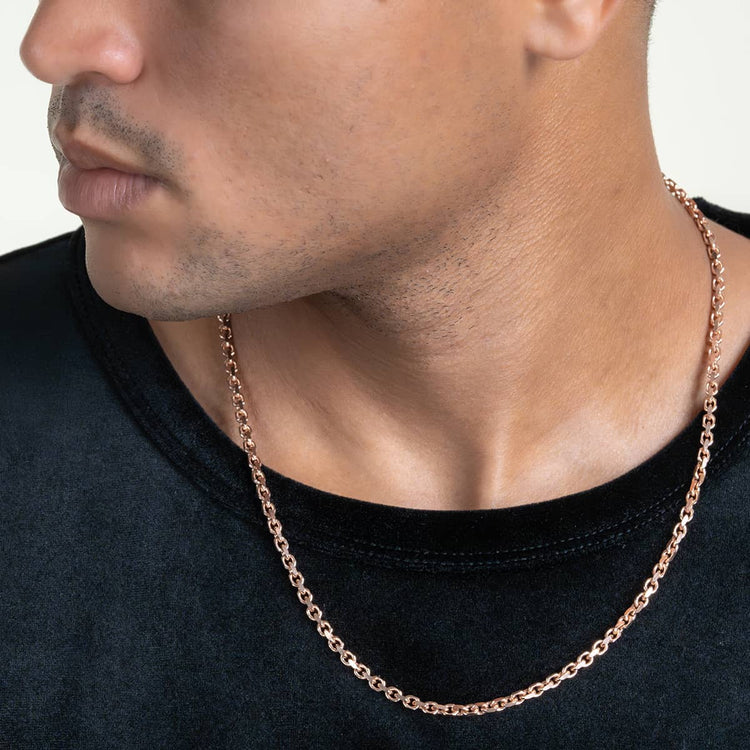 Close-up of a person wearing a black shirt and the 3.5mm Solid Rose Gold Cable Link Chain. The image highlights the necklace’s shine and intricate detail on the lower half of the face, neck, and upper chest.