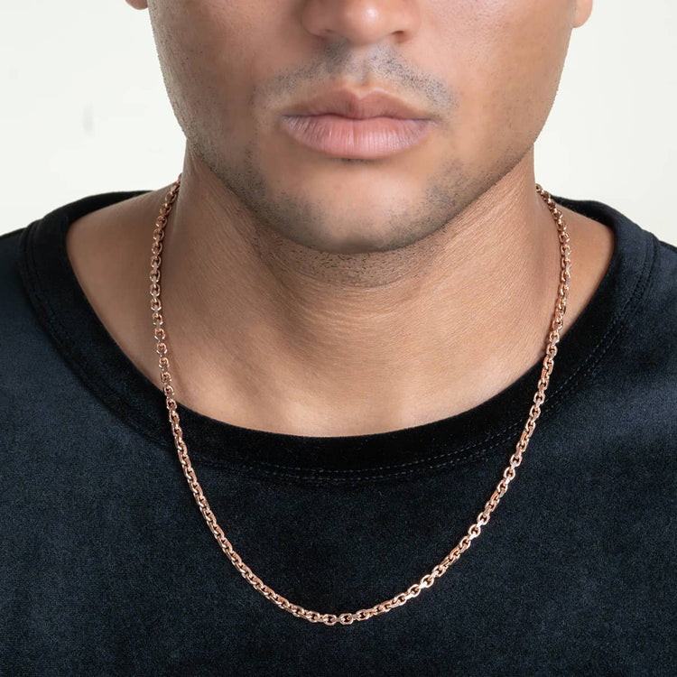 A person wearing a black shirt and the 3.5mm Solid Rose Gold Cable Link Chain, shown from the shoulders up with focus on the necklace. Their face is mostly visible and features a neutral expression.
