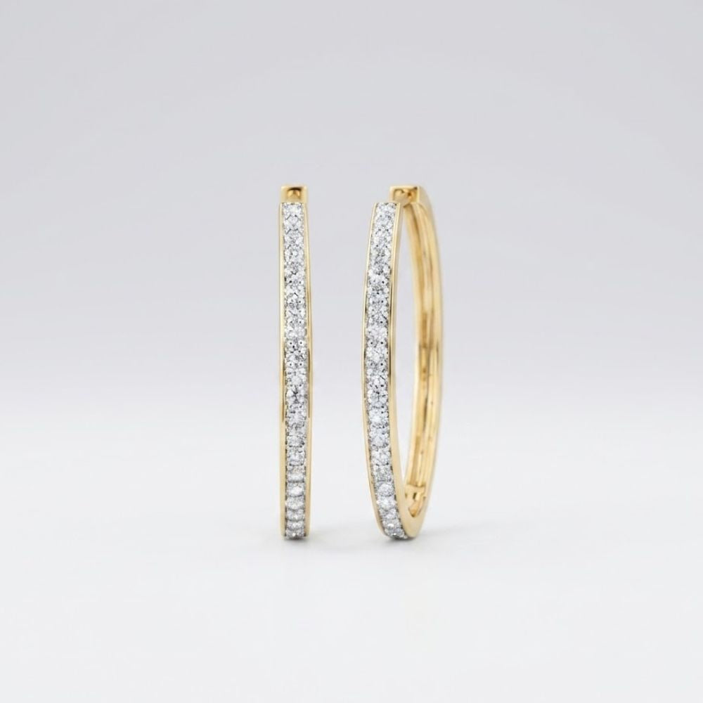 The 14k Yellow Gold Diamond Fashion Hoop Earrings 7/8CTW are shown upright on a plain white background, featuring hoops encrusted with small natural diamonds along the front outer edge.