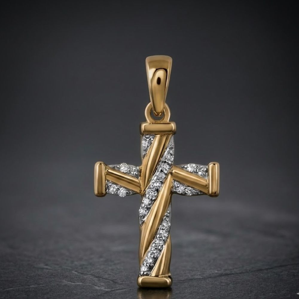 The 1/20 CTW Diamond Cross Pendant in 10K Gold features diagonal rows of sparkling diamonds at its center, showcased on a dark, textured surface with a softly blurred background.