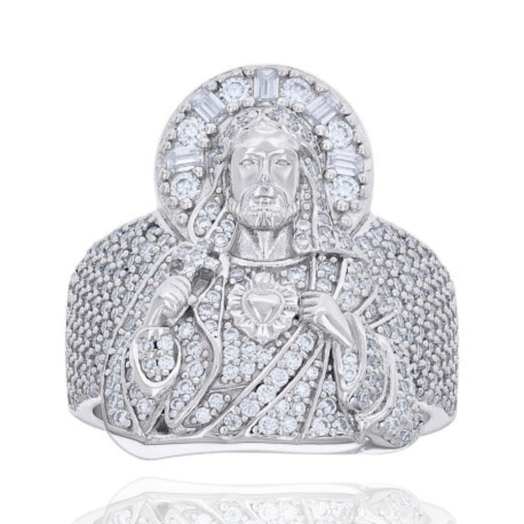 The Baguette 2.1ct Moissanite Jesus Religious Ring is crafted from sterling silver, featuring a detailed Jesus with a radiant halo and sparkling moissanite stones set throughout the design.