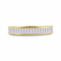 The 10k Yellow Gold Baguette Diamond Wedding Band 1/2 Cttw showcases a row of vertically set rectangular baguette diamonds along the sleek band in a modern design, shown against a plain white background.