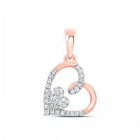 This 10K Gold Diamond Heart Pendant (1/10 CTW) features a rose gold heart outline, partially set with diamonds, and a smaller diamond heart cluster inside. The bail is also rose gold—a stunning piece for any collection.