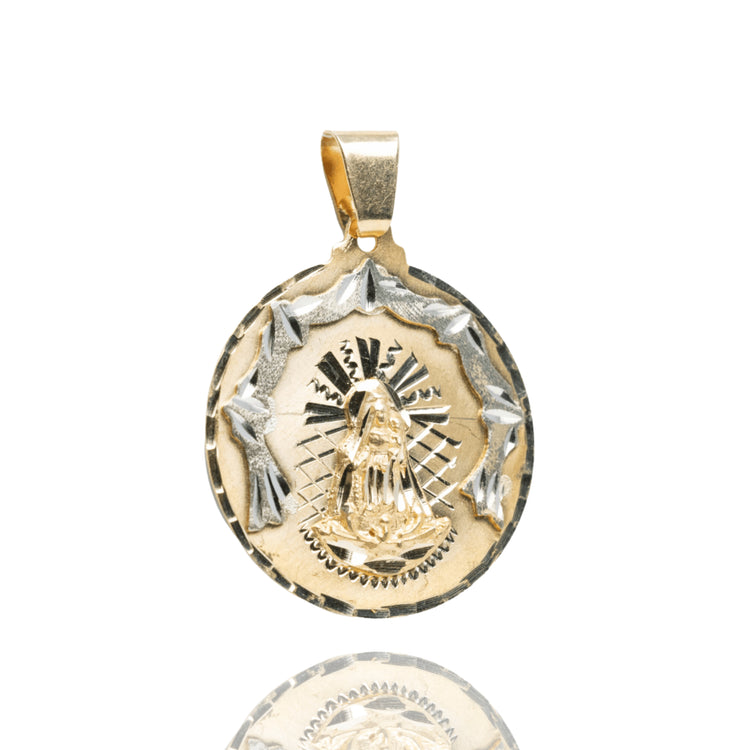 A Circular Caridad Del Cobre, Lady of Charity Pendant in 14k solid yellow gold features a raised Virgin Mary with a decorative border, displayed on a white background with a subtle reflection below.