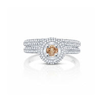 The 14k Yellow Gold Brown Diamond Bridal Engagement Ring Set features a champagne-hued center stone, two halos of white diamonds, and a triple-band diamond shank—making it a timeless wedding ring choice.