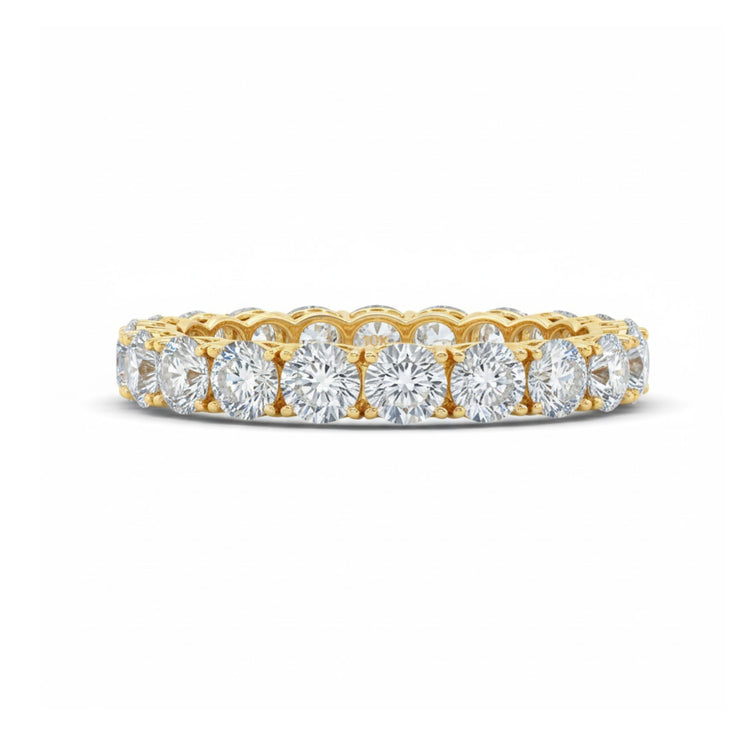 The 5/8CTW Natural Diamond Ana M Eternity Band in 14k gold features a continuous row of round, sparkling white diamonds closely set around the band—an elegant choice for a wedding ring.