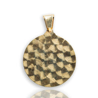 The Saint Lazarus Circular Pendant is a 14K solid gold men’s pendant featuring a hammered, textured round design with a simple gold bail, shown against a white background with a subtle reflection below.