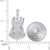 The Men’s Moissanite Jesus Pendant in 925 silver is shown next to a U.S. quarter for size reference, with both resting on a surface marked with inch ruler measurements.