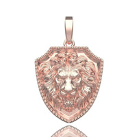 The 14k Gold Lion Shield Pendant has a rose gold shield and detailed lion’s head center, with a loop for easy attachment—an eye-catching necklace piece for any collection.