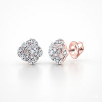 The 1/5CTW Natural Diamond Rose Earrings 10K Gold feature rose-shaped studs with sparkling natural diamonds in a spiral design and secure 10k gold screw-back posts, shown on a white background.