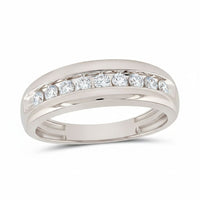 The 10k Gold Round Diamond Wedding Band 1/2 Cttw showcases seven round-cut diamonds in a channel setting with a polished split shank, offering a sophisticated and elegant choice for a wedding band—displayed on a white background.