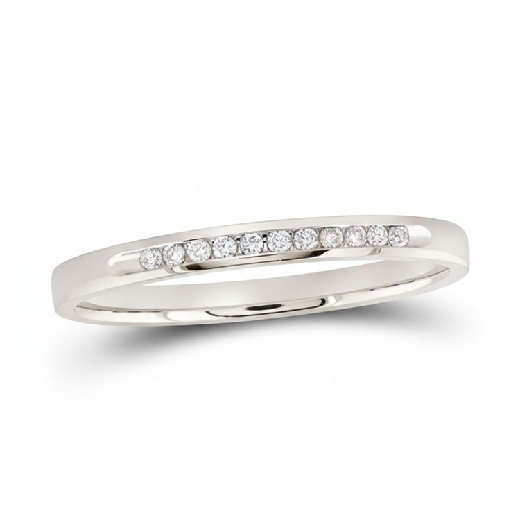 The 14k White Gold Channel-Set Diamond Wedding Band 1/10 Cttw showcases a slim design with a single row of channel-set diamonds across the top, displayed on a white background.