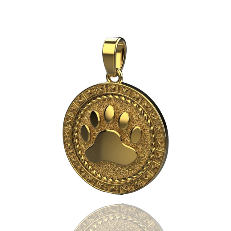 The Golden Dog Paw Pendant – 14K Solid Yellow Gold for Men features a raised paw print and ornate textured border, with a top loop for necklaces—a stylish piece of men’s pet jewelry.