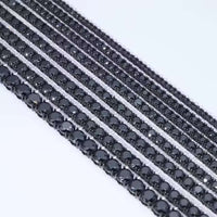 Black Moissanite Tennis Bracelets are displayed parallel on a light surface, each bracelet featuring round black moissanite stones set closely together in 925 sterling silver settings.