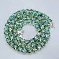 The Green Moissanite Tennis Chain - 4mm features three rows of large, round, sparkling light green stones that reflect rainbow hues, reminiscent of a coiled silver bracelet, shown on a plain white background.