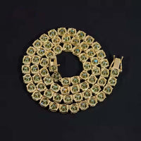 The Green Moissanite Tennis Chain - 4mm features round light green moissanite gems set in a continuous spiral pattern, showcased against a black background.