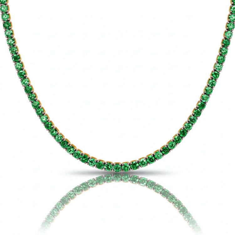 The Green Moissanite Tennis Chain - 3mm is displayed in a curved shape on a white background, featuring round green gemstones with a subtle reflection beneath.