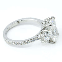 A close-up side view of the 4.84 CTW 14k White Gold Three Stone Radiant Engagement Ring, featuring a radiant-cut lab-grown center diamond, two smaller side diamonds, and accent diamonds set along the band.