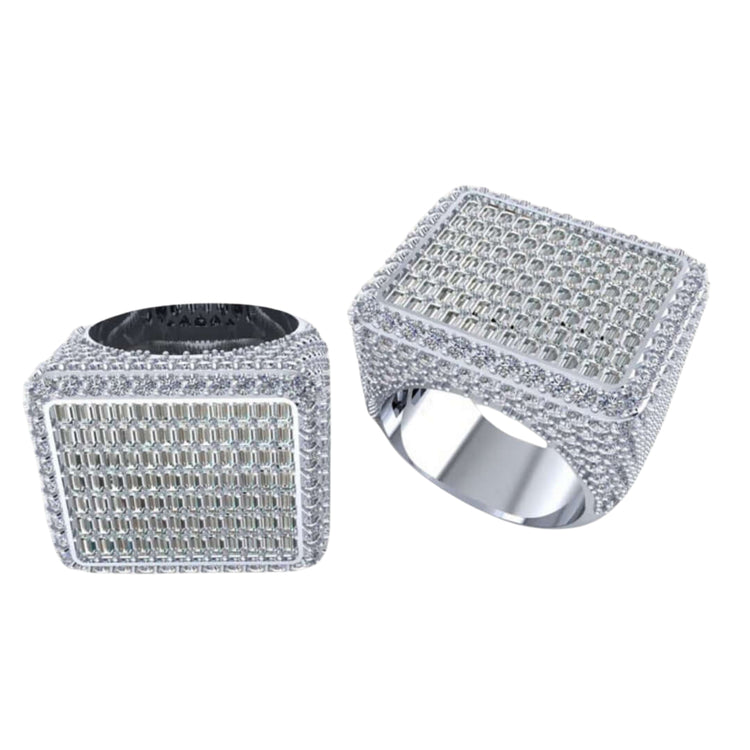 The Iced-Out Square Baguette Signet Ring – 7.20 CT features a large, rectangular silver design encrusted with rows of sparkling diamonds on the top and sides, showcased elegantly on a white background.