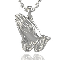 A timeless alternative to the classic 14k Gold Praying Hands Pendant, this silver pendant features two hands in prayer with polished, detailed fingers and cuffs that catch the light, hanging elegantly from a chain.