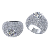 The Domed Solitaire Diamond Ring – 15.21 CT Gold Design features a bold, wide style with a large central diamond and is adorned with sparkling smaller diamonds, creating a brilliant shimmer from every angle.