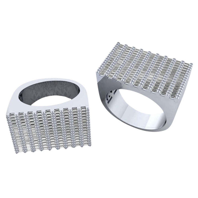 Two silver Baguette Stack Diamond Rings – 1.56 CT Gold Design, each with wide rectangular faces encrusted in grid-set clear stones; one ring stands upright while the other lies on its side, evoking classic baguette diamond style.