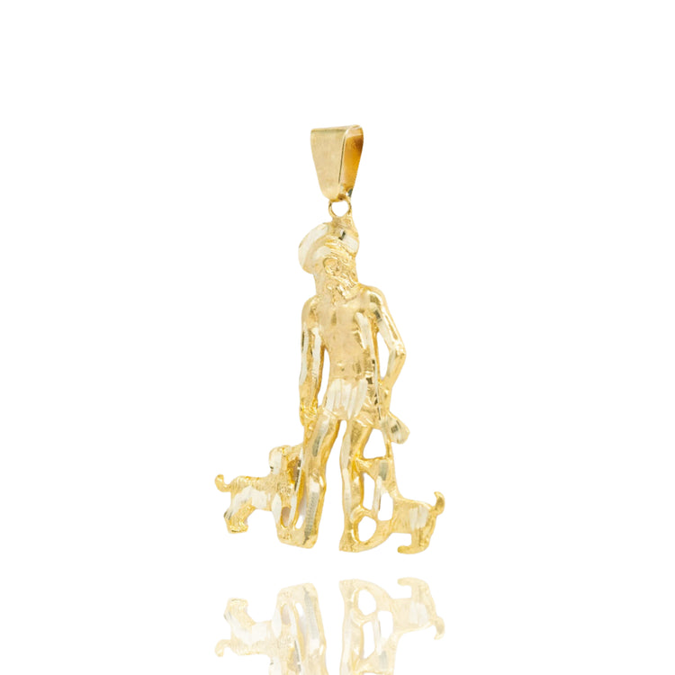 The Saint Lazarus Pendant – 14K Gold Men’s Pendant shows a standing man in a hat with two small dogs at his feet. This detailed, textured religious piece is displayed on a white background with a subtle reflection below.