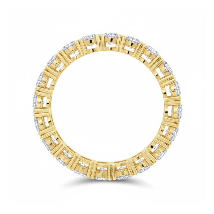 The 5/8CTW Natural Diamond Ana M Eternity Band in 14k gold features alternating vertical gold bars and sparkling natural diamonds in a symmetrical pattern around the band.