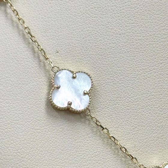 White Four Leaf Clover Necklace - 14k Yellow Gold Elegant 14k yellow gold necklace with a luminous white four leaf clover pendant. A symbol of luck and delicate beauty. Shop the White Clover Necklace today!