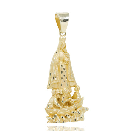 The Lady of Charity Large Pendant – Yellow Gold is a men’s religious pendant featuring a robed figure above two people in a boat, with textured and polished finishes and small dark robe accents.