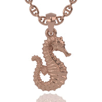 The 14k Gold Seahorse Pendant features intricate textures and a highly polished finish. Hanging from a thick matching chain, this rose gold necklace is both elegant and eye-catching.