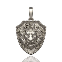 The 14k Gold Lion Shield Pendant is shaped like a shield and features a detailed, three-dimensional lion's head with a fierce expression and flowing mane.
