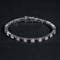 The Black Moissanite Tennis Bracelet - 4mm, made from 925 sterling silver, showcases alternating black and white square-cut gemstones, creating a bold and elegant look.