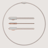 An elegant 4mm Diamond Cuban Link Chain 14k, paired with woven chain bracelets and diamond-encrusted rectangular clasps, is beautifully displayed on a light background.