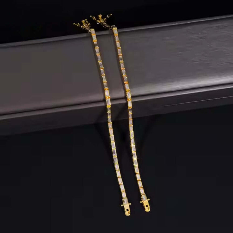 Two Emerald Moissanite Tennis Bracelets (4mm) with rectangular links, each set with clear emerald-cut moissanite stones, are displayed side by side on a dark surface against a black background.
