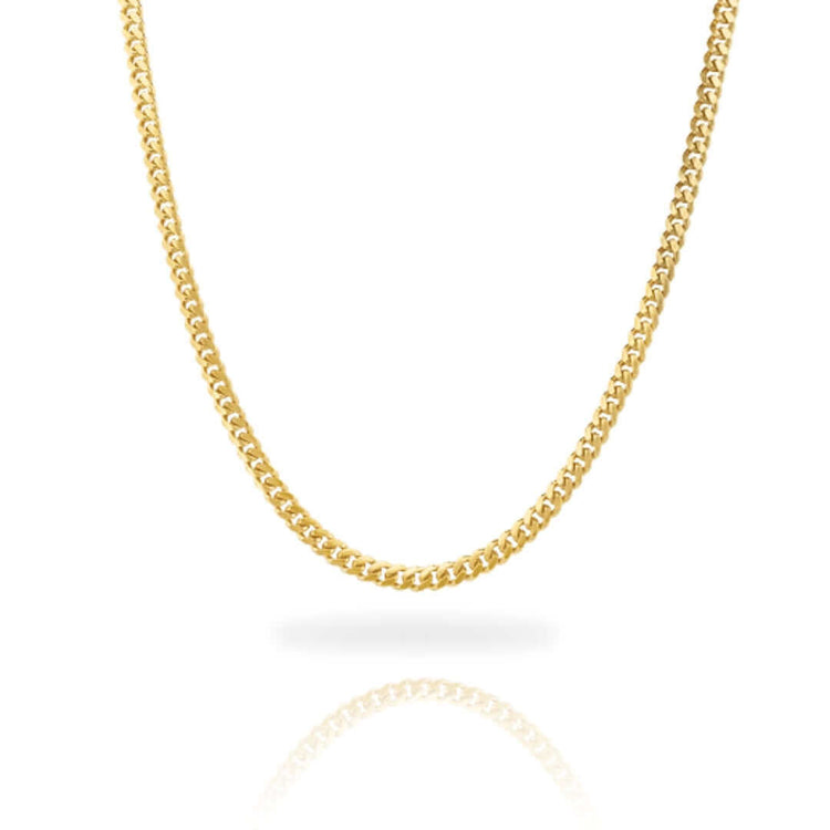 The Cuban Link Chain Solid Gold 4mm - Box Lock is featured against a white background. Its classic curb link design forms a smooth curve, with the gold chain and its reflection visible below.