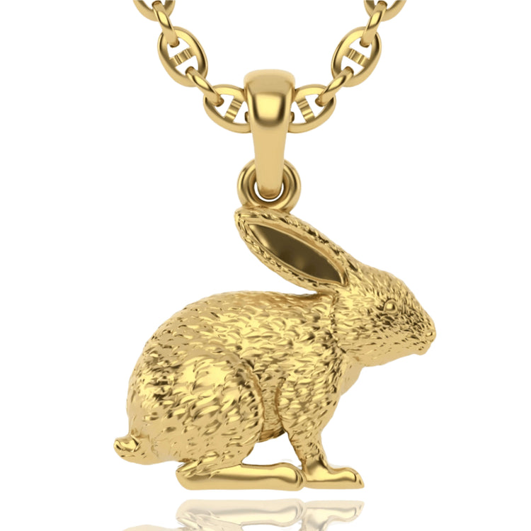 The 14k Gold Rabbit Pendant features a detailed, textured sitting rabbit with upright ears, inspired by nature, and hangs elegantly from a round link chain.