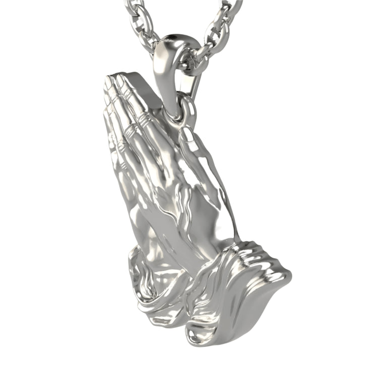 A 14k gold praying hands pendant shaped like two hands pressed together in prayer, detailed with realistic fingers and draped sleeves.