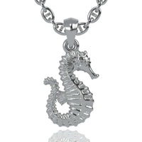 A lustrous 14k gold seahorse pendant is displayed against a white background. This elegant jewelry piece features textured lines and curves, accentuating the seahorse’s body and curled tail.