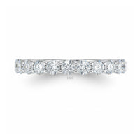 The 14k White Gold Diamond Eternity Ring 2 Cttw is shown from the side against a white background, featuring a row of sparkling round diamonds and "14K" faintly visible below them.