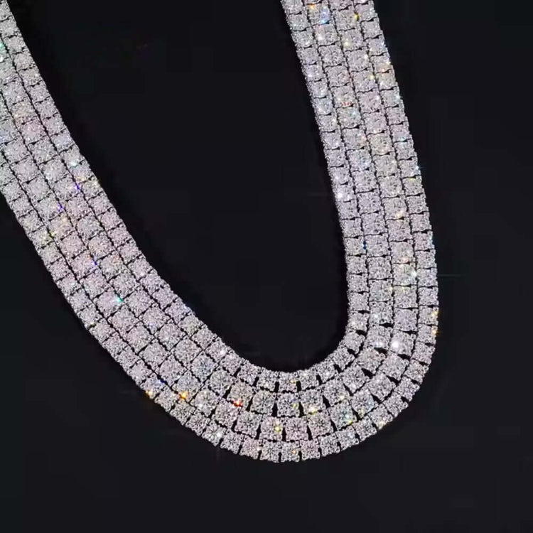The Iced Out Moissanite Tennis Chain - 5mm features double layers of shimmering stones set in silver, showcased on a black background.