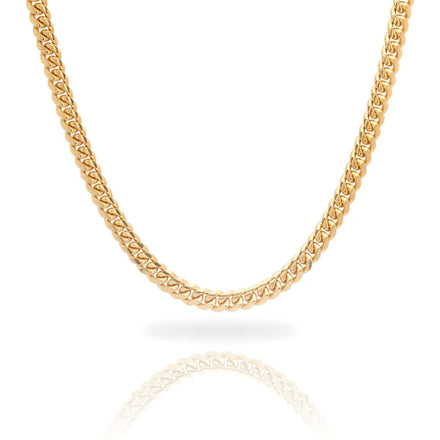 A close-up of the Cuban Link Chain Solid Gold 6mm - Box Lock, featuring a thick, intricate link design, displayed on a white background with a subtle reflection beneath.