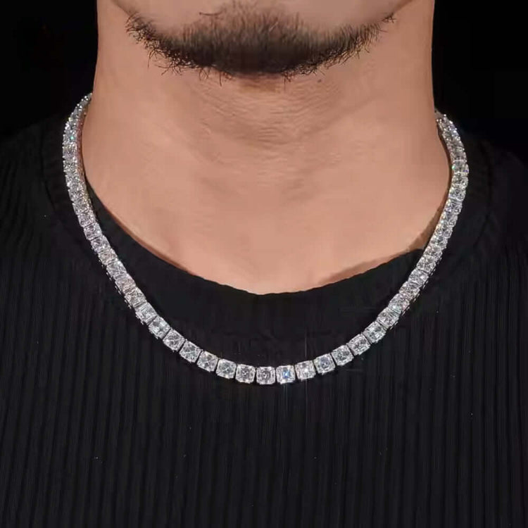 A close-up of a person wearing the Square Moissanite Tennis Chain - 5mm over a black ribbed shirt, with the lower half of their face visible.