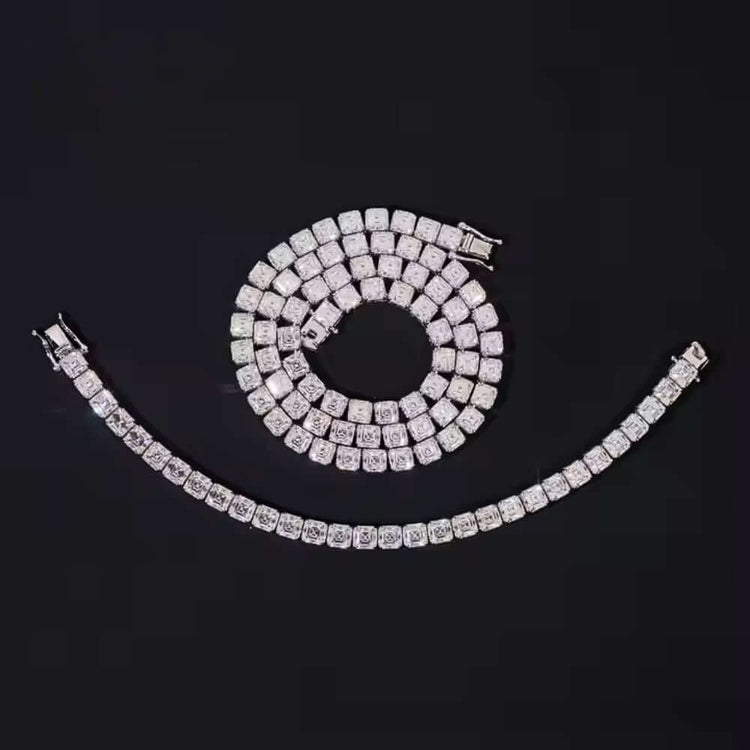 A Square Moissanite Tennis Chain - 5mm is coiled in a spiral with a matching bracelet set below it, both shimmering against a solid black background.