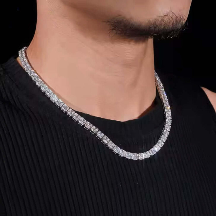 Close-up of a person wearing a black ribbed shirt and the Square Moissanite Tennis Chain - 5mm, sparkling around their neck against a dark background.
