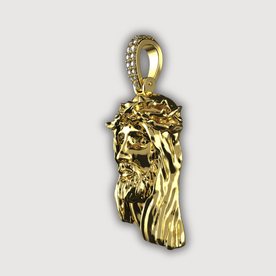 14K gold Jesus face pendant with diamond bail, showcasing intricately crafted design and spirituality.