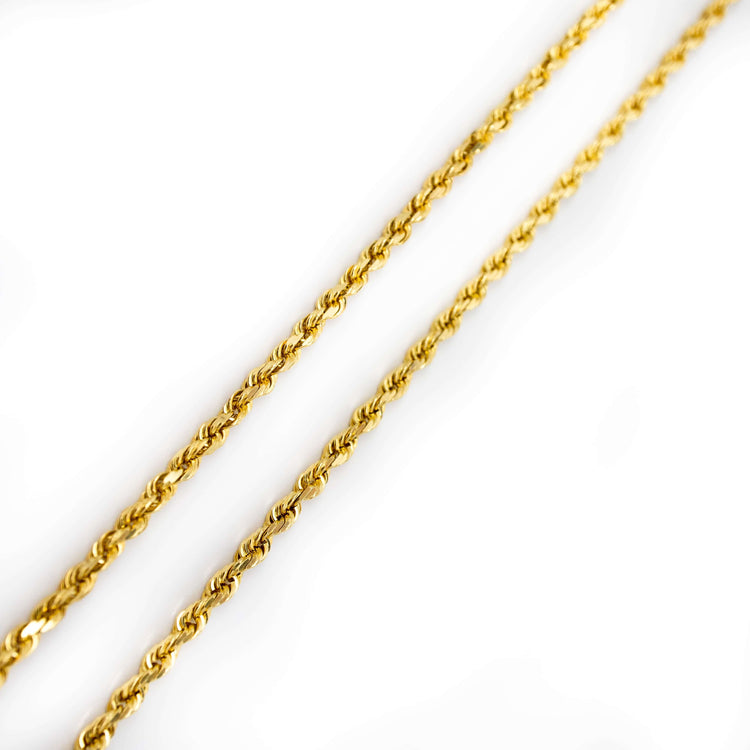 Two Rope Chain necklaces (6mm & 10mm) in hollow yellow gold are displayed diagonally on a white background, highlighting their twisted, intertwined links and shiny finish. One stands out with its bold, statement rope chain design.